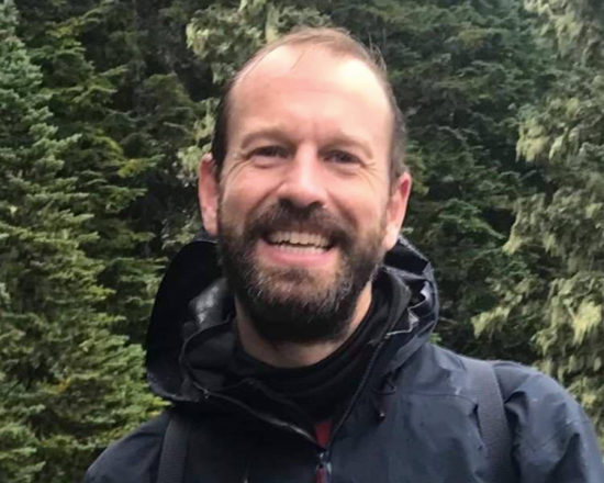 bearded man smiling at camera