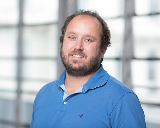 man in blue shirt smiling at camera