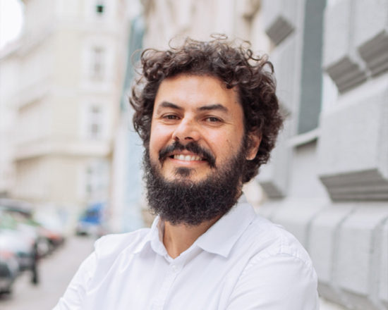 man with beard smiling at camera